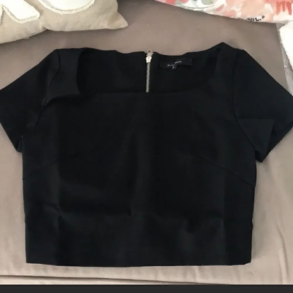 Black crop top with full exposed silver zipper